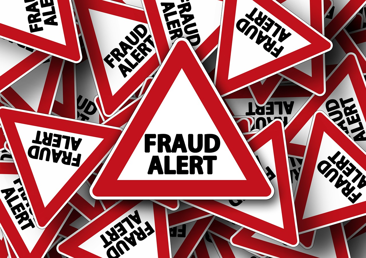 Many signs saying "Fraud Alert" scattered on top of each other.